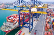 Container ships at industrial ports in the business of import, export, logistics and international maritime transport, loading of containers on cargo ships with cranes,
Transportation of goods by container trucks to customers.