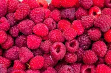 Composition of raspberries fruits in a box